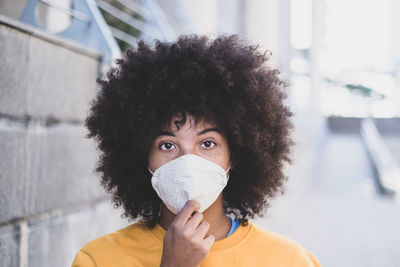 Portrait of young woman covering face