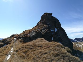 Low angle view of rock formation against sky