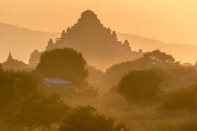 Panoramic view of temple against sky during sunset