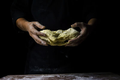 Close-up of man holding ice cream on table