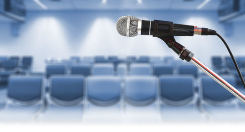 Close-up of microphone in empty seminar hall