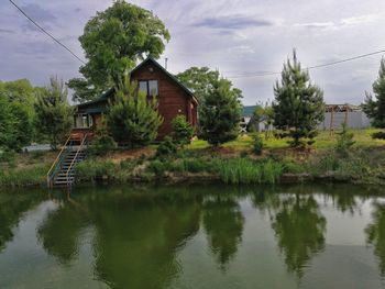 House by trees against sky