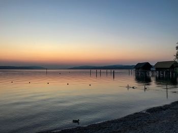 Scenic view of sea against clear sky during sunset