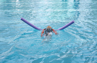 Portrait of man swimming in pool