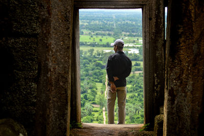 Rear view of man standing in corridor