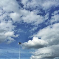 Low angle view of street light against cloudy sky