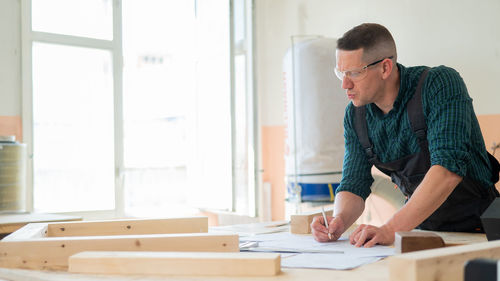 Side view of businessman working at office