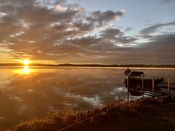 Scenic view of lake against sky during sunset