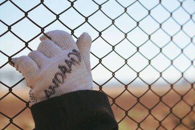 Person seen through chainlink fence