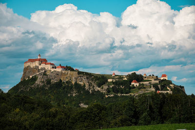 Panoramic view of castle and buildings against sky