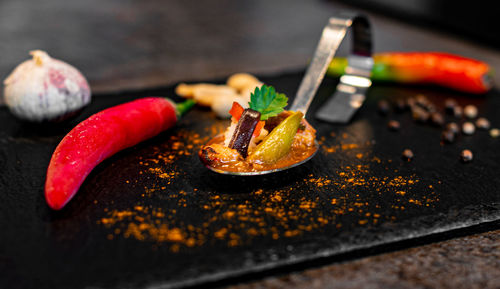 Close-up of red chili peppers on table