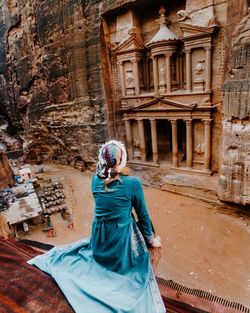 Rear view of woman looking at historic building