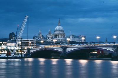 Illuminated bridge against sky in city