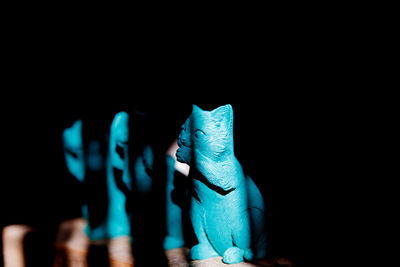 Close-up of blue toy against black background