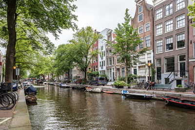 Canal by buildings in city