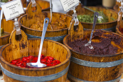 Close-up of preserves in wooden buckets for sale