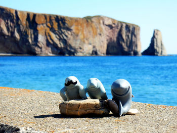 Rocks on beach against sky