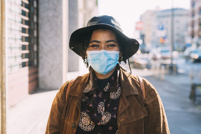 Portrait of young woman standing on street