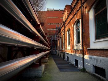 Empty alley amidst buildings in city