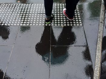 Reflection of people in puddle