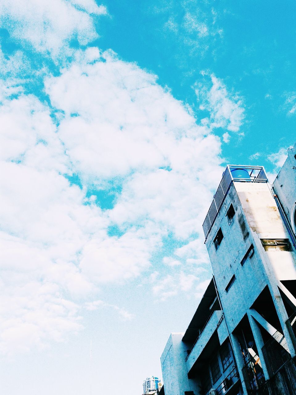 building exterior, architecture, low angle view, built structure, sky, blue, cloud - sky, building, residential building, cloud, residential structure, window, day, city, outdoors, high section, no people, cloudy, house, sunlight