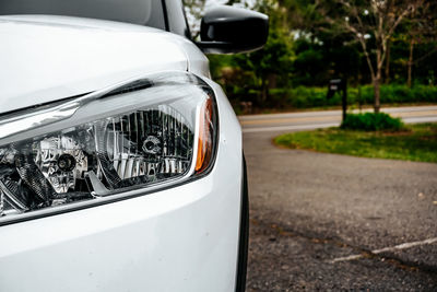 Close-up of car on road