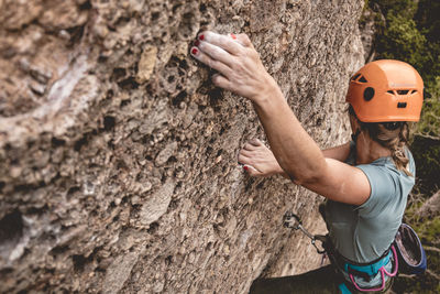 View from above of a girl climbing without looking at the camera
