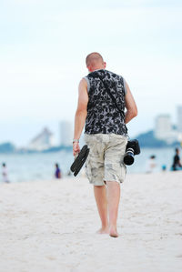 Full length of woman standing on beach