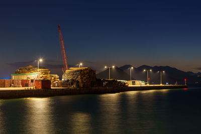 Illuminated city at waterfront