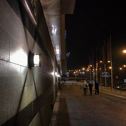 People in illuminated city at night