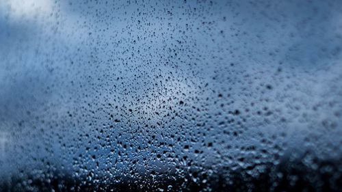 Full frame shot of wet glass window during monsoon