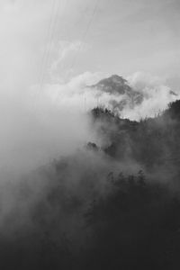 Scenic view of mountains against cloudy sky