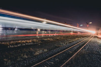 Light trails on railroad track at night