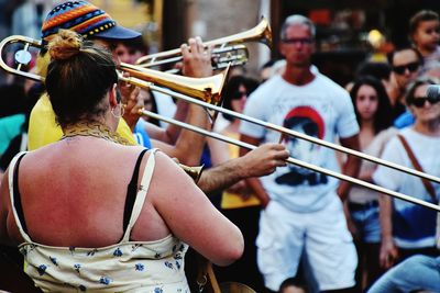 Rear view of people playing music concert
