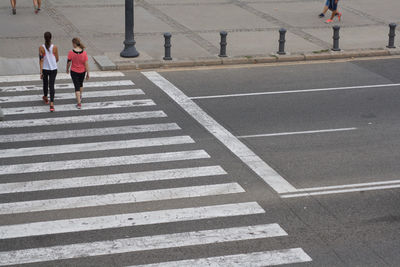 High angle view of females crossing road in city