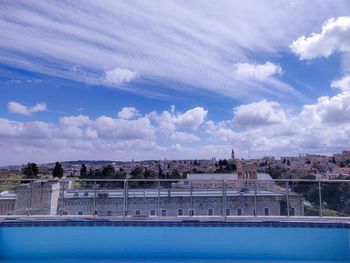 View of swimming pool against cloudy sky