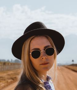 Portrait of beautiful woman standing on sand