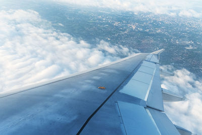 Aerial view of cloudscape over airplane wing