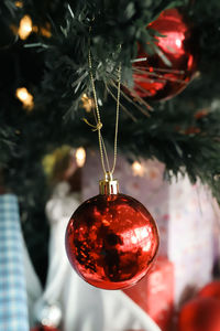 Close-up of christmas decorations hanging on tree