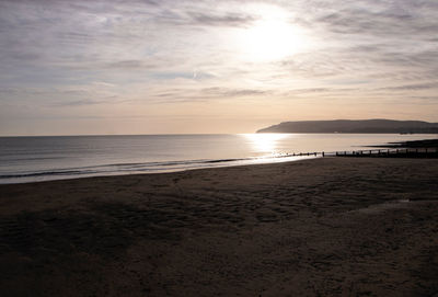 Scenic view of beach against sky during sunset