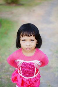 Portrait of girl standing on field