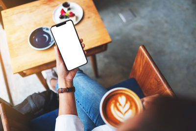 Low section of woman using mobile phone