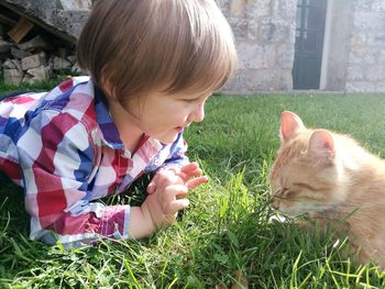 Boy with horse in grass