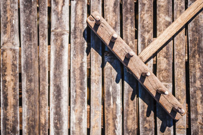 High angle view of wooden rake on planks