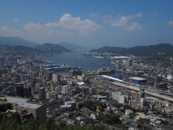 High angle view of townscape by sea against sky