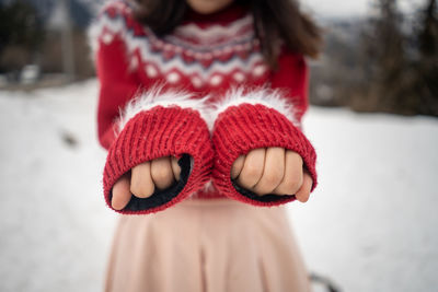 Midsection of woman wearing warm clothing standing outdoors