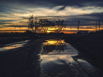 Reflection of clouds in sea at sunset