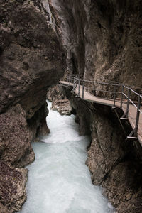 Bridge over river amidst rock formation