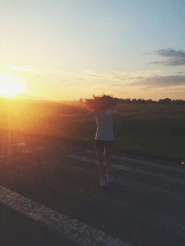 sunset, sky, rear view, lifestyles, leisure activity, tranquil scene, full length, standing, tranquility, scenics, walking, landscape, beauty in nature, silhouette, sun, nature, men, road