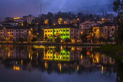 Reflection of buildings in city at night